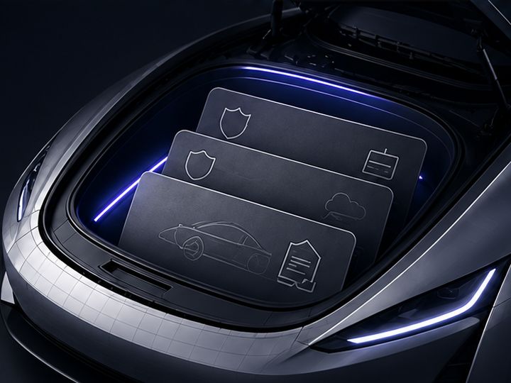 The open front trunk holding three slate cards embossed with a shield, a car, a cloud and a document, lit in violet